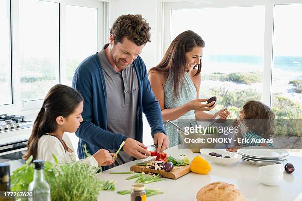 family preparing food in the kitchen - cut out happy ストックフォトと画像