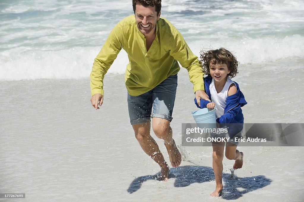 Man playing with his son on the beach