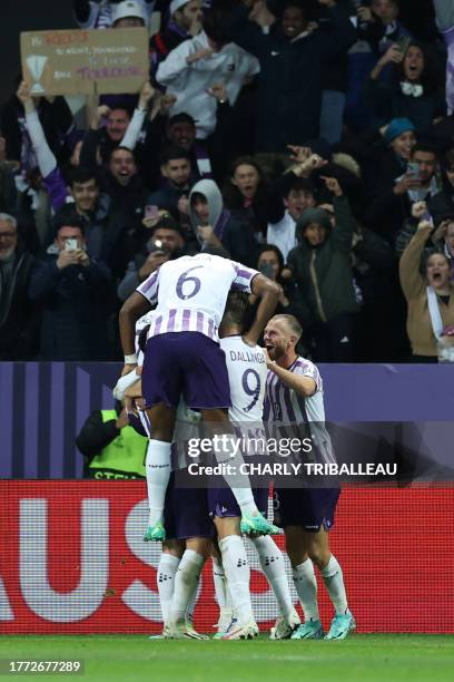 Toulouse's players celebrate scoring their third goal in front of their fans during the UEFA Europa League Group E football match between Toulouse FC...