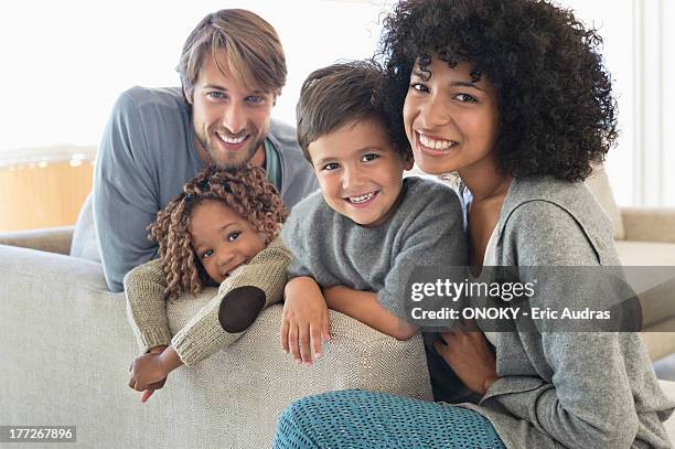 portrait of a couple smiling with their children - 2 year old blonde girl father stock pictures, royalty-free photos & images