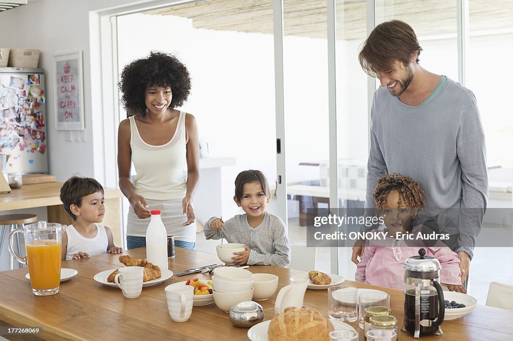 Family smiling at a breakfast table