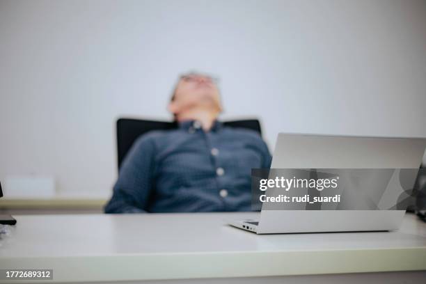 shot of a business man looking stressed while working in a modern office - work mistake stock pictures, royalty-free photos & images