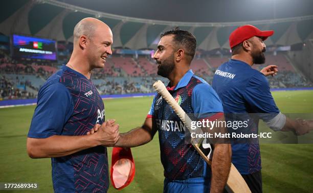 Jonathan Trott, Head Coach of Afghanistan and Hashmatullah Shahidi of Afghanistan celebrate following the ICC Men's Cricket World Cup India 2023...