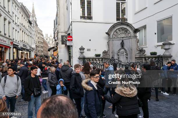 Daily life in Brussels with crowds at one of the tourist attractions in the city, the Manneken Pis or the Little man Pee or peeing boy or le Petit...