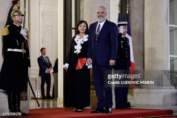 Albania's Prime minister Edi Rama and his wife Linda Rama pose as they arrive to attend the dinner in honour of the Heads of State and Government and...
