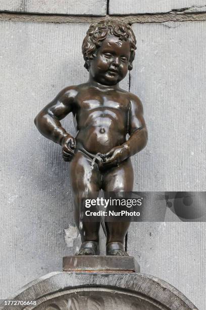 Daily life in Brussels with crowds at one of the tourist attractions in the city, the Manneken Pis or the Little man Pee or peeing boy or le Petit...