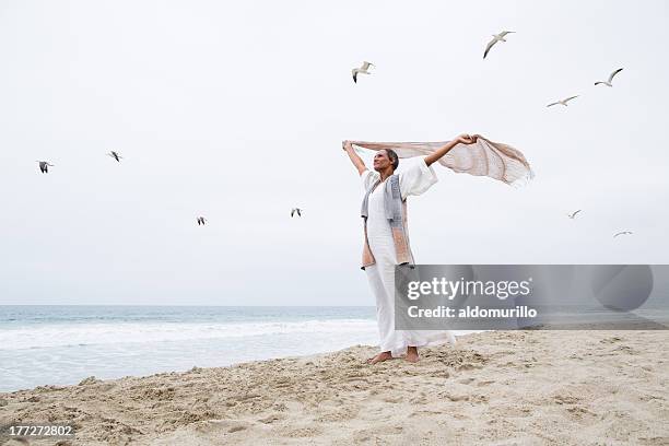 senior woman freedom - woman flying scarf stock pictures, royalty-free photos & images