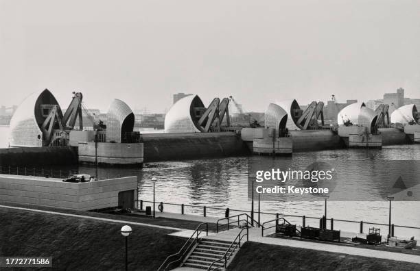 The gates of the Thames Barrier on the River Thames in London, England, April 1984. The completed flood defence is shown ahead of its official...