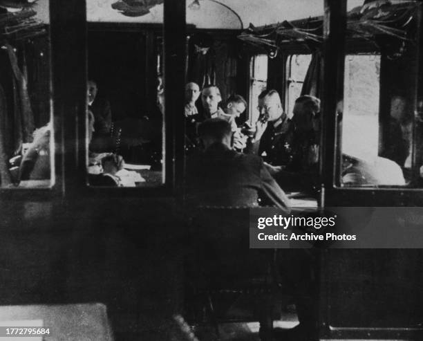 French and German delegates sitting in a railway carriage to sign the armistice agreement that brought a cessation of Franco-German hostilities, in...