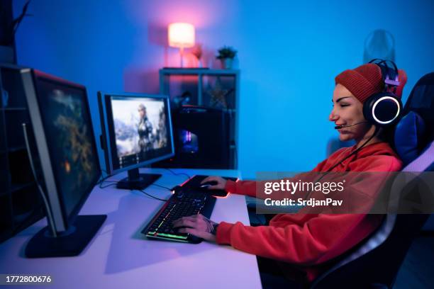 modern young caucasian female gamer playing video games on computer - heroes icon stock pictures, royalty-free photos & images