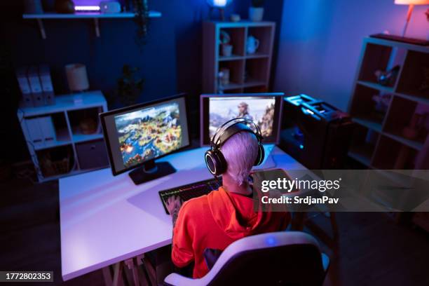 unrecognizable female gamer, playing video games on her pc during a live stream - heroes icon stock pictures, royalty-free photos & images