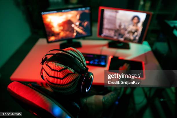 unrecognizable caucasian female gamer playing video games on computer - heroes icon stock pictures, royalty-free photos & images