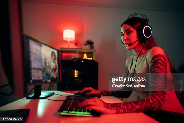 female gamer playing multiplayer video games on computer - heroes icon stock pictures, royalty-free photos & images