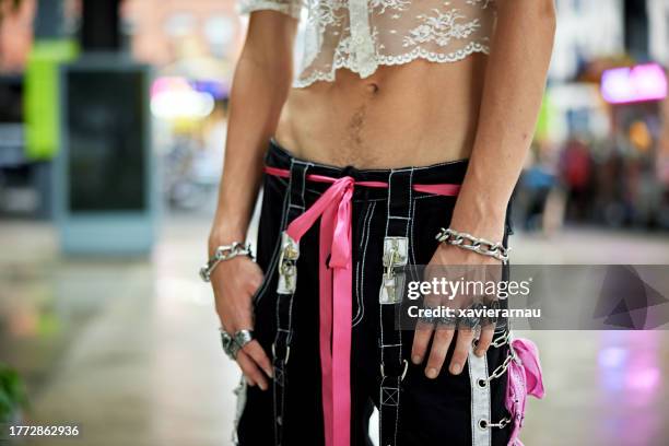 gay man wearing crop top and pants with pink accessories - pink belt stock pictures, royalty-free photos & images