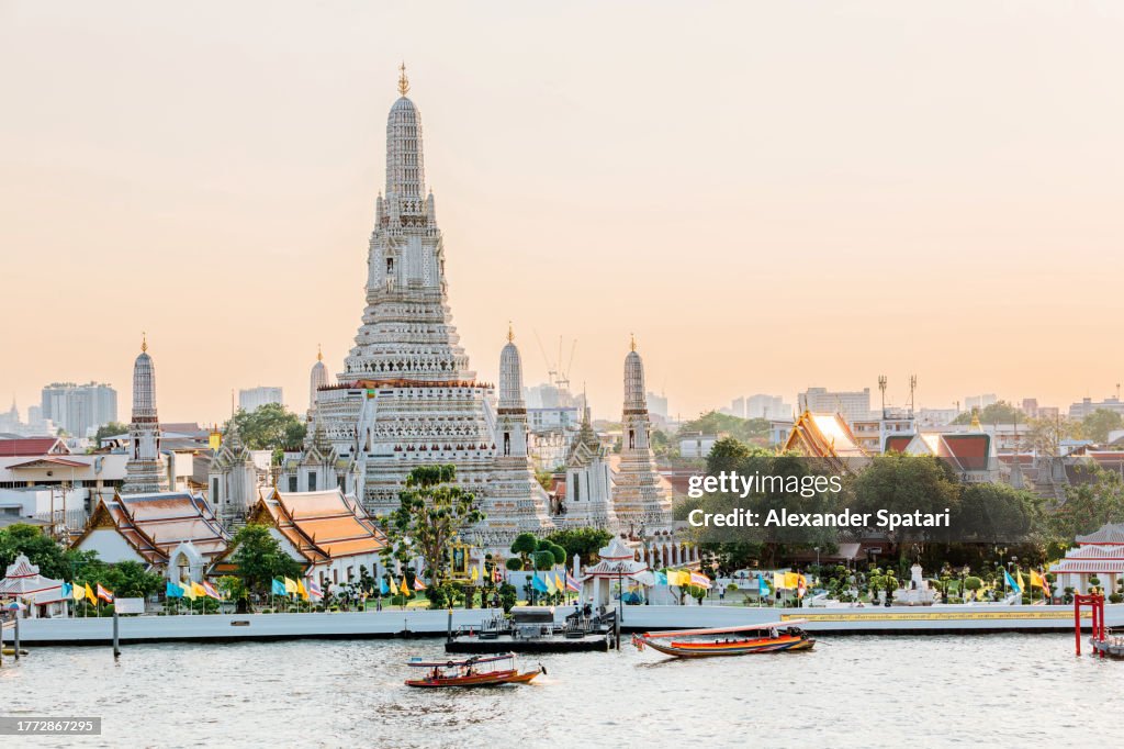 Wat Arun Buddhist temple and Chao Phraya river on a sunny day, Bangkok, Thailand