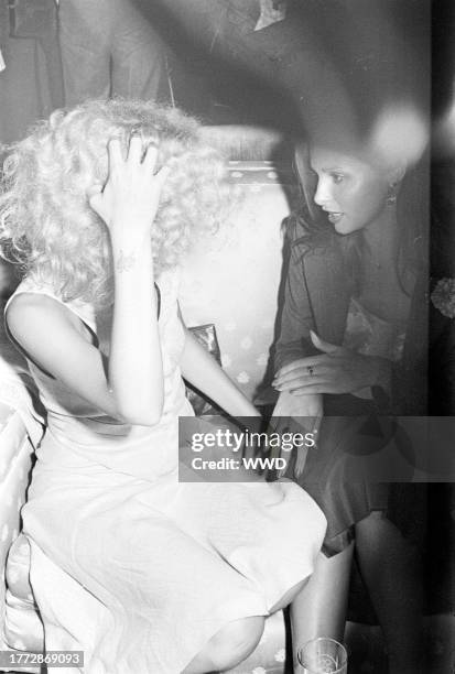 Genevieve Waite and Apollonia van Ravenstein attend a party at On the Rox, a nightclub in West Hollywood, California, on July 28, 1975.