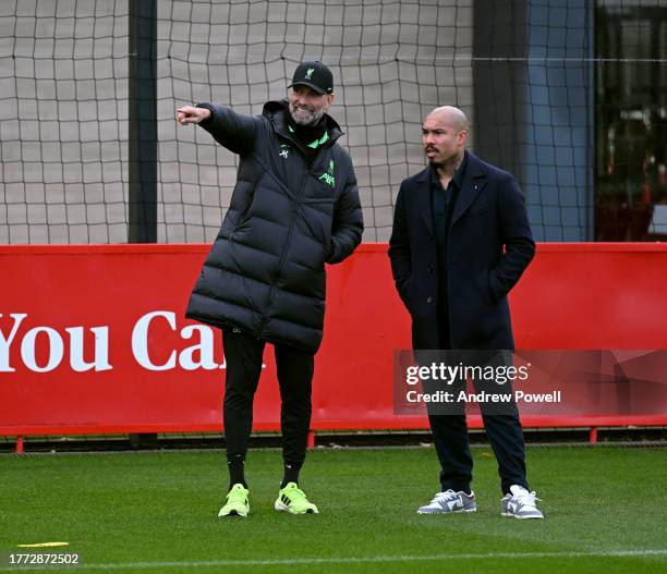 Jurgen Klopp manager of Liverpool with Nigel de Jong former professional footballer during a training session at AXA Training Centre on November 03,...