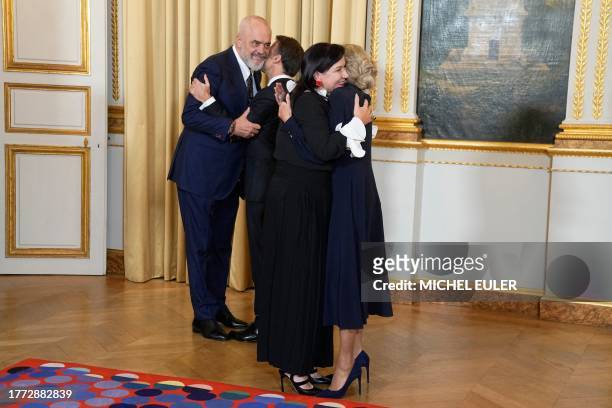 French President Emmanuel Macron and his wife Brigitte Macron greet Prime Minister of Albania Edi Rama and his wife Linda Rama as they attend a...