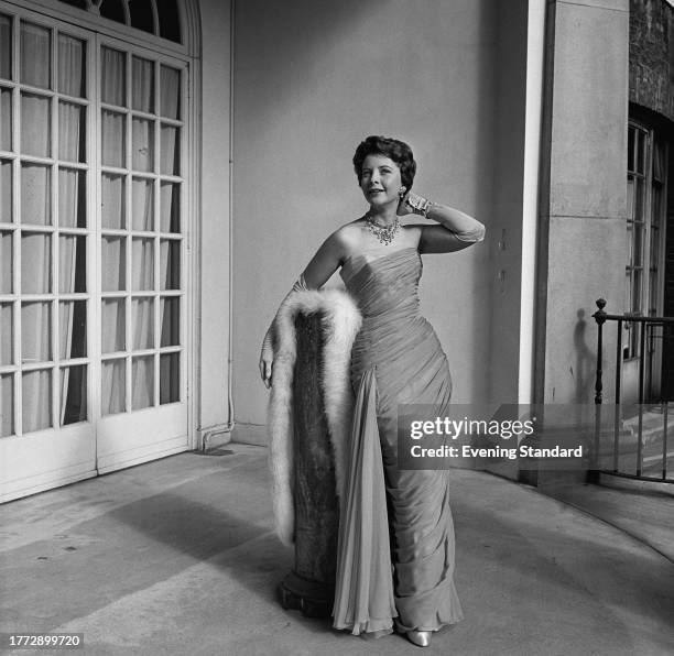 Actress June Thorburn poses while dressed in an evening gown with fur shawl during a Royal Film Performance, October 29th 1956.