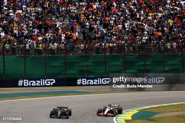 Lewis Hamilton of Great Britain driving the Mercedes AMG Petronas F1 Team W14 and Kevin Magnussen of Denmark driving the Haas F1 VF-23 Ferrari on...