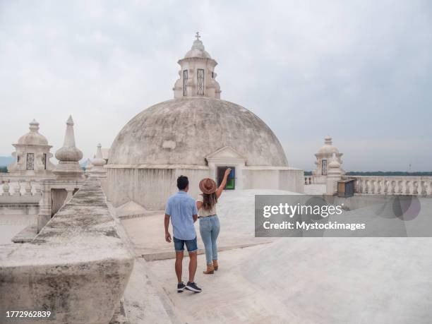 cheerful couple sightseeing in leon city, they on the rooftop of a church - cultura guatemalteca imagens e fotografias de stock