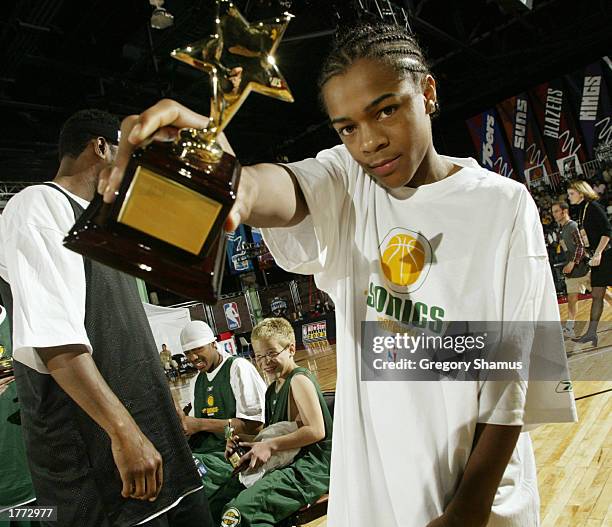 Bow Wow shows off his first place trophy from the Celebrity Shooting Stars competition on February 9, 2003 at the NBA All Star 2003 Jam Session in...