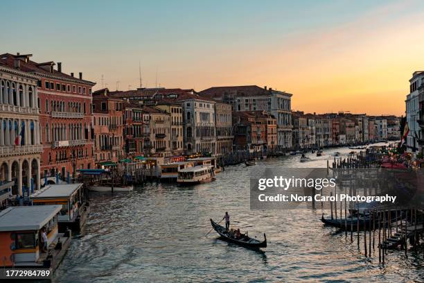 gondola during sunset in grand canal venice - gondel stock-fotos und bilder