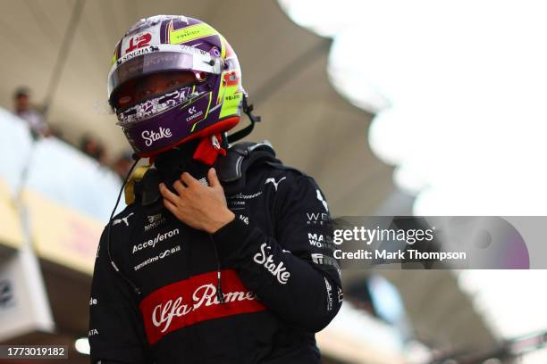 20th placed qualifier Zhou Guanyu of China and Alfa Romeo F1 walks in the Pitlane during qualifying ahead of the F1 Grand Prix of Brazil at Autodromo...