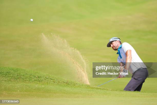 Scott Harrington of the United States plays a shot from a bunker on the first hole during the second round of the World Wide Technology Championship...