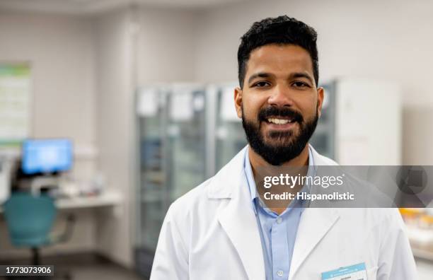 happy doctor working at the hospital laboratory - hematology stock pictures, royalty-free photos & images