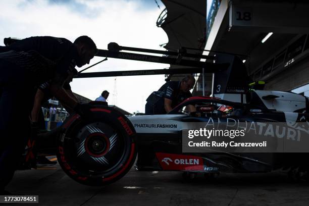 Yuki Tsunoda of Japan driving the Scuderia AlphaTauri AT04 is pushed back into the garage during qualifying ahead of the F1 Grand Prix of Brazil at...
