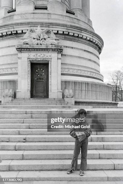 Young boy holding a baseball glove in front of the Soldiers and Sailors Monument in Riverside Park on the Upper West Side of New York City, 1971.