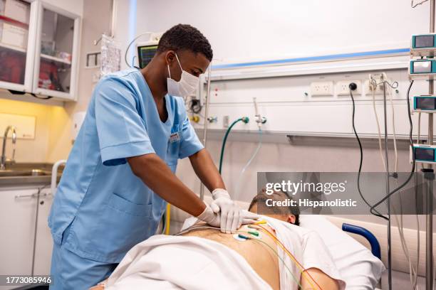 nurse doing cpr on a patient in the emergency room - cpr stock pictures, royalty-free photos & images