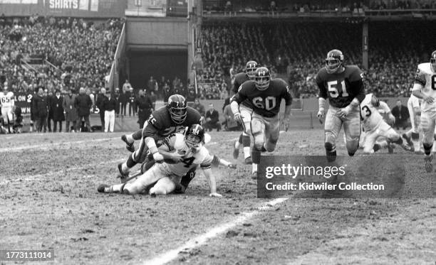 Jim Katcavage of the New York Giants tackles Bill Nelsen of the Pittsburgh Steelers during a game at Yankee Stadium on December 5, 1965 in New York,...