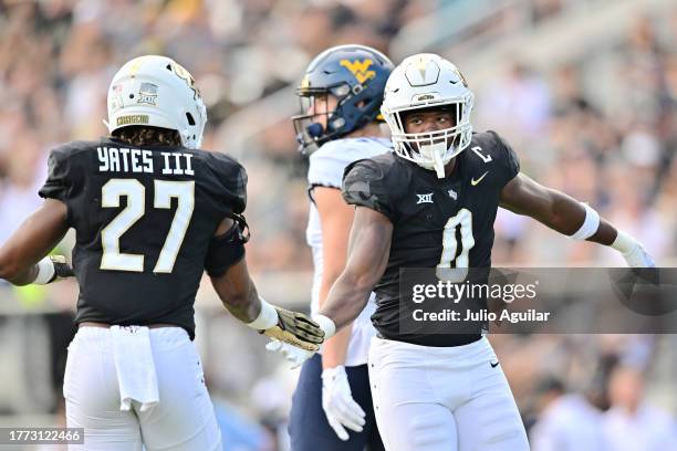 Walter Yates III and Jason Johnson of the UCF Knights react during the first half of a game against the West Virginia Mountaineers at FBC Mortgage...