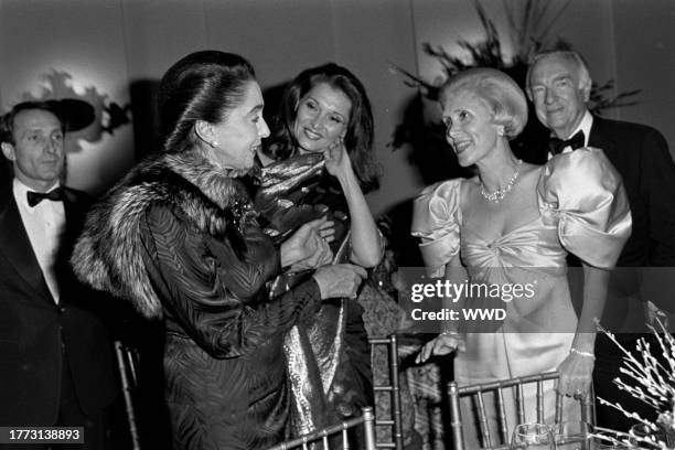 Guest, Mica Ertegun, Nancy Kovack, Alice Brooks, and Walter Cronkite attend an event at the flagship location of Lord & Taylor on November 28, 1984.