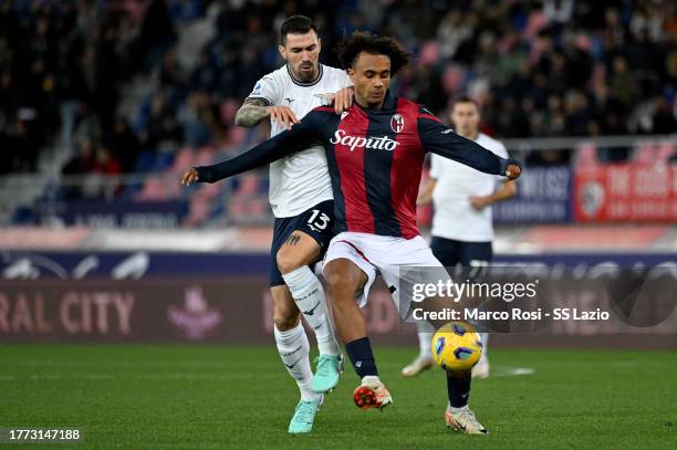 Alessio Romagnoli of SS Lazio compete for the ball with Joshua Zirkee during the Serie A TIM match between Bologna FC and SS Lazio at Stadio Renato...