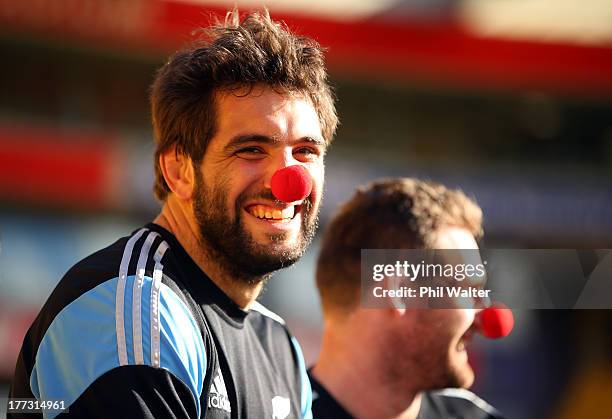 Sam Whitelock and Kieran Read of the All Blacks wear red noses for charity during a New Zealand All Blacks Captain's Run at Westpac Stadium on August...