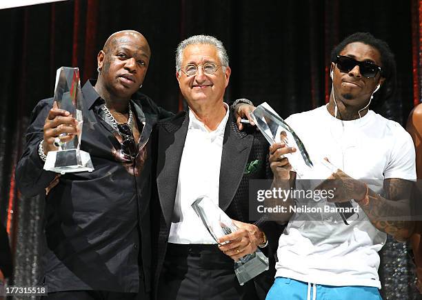 Birdman, BMI President and CEO, Del Bryant and Lil Wayne speak onstage at the 2013 BMI R&B/Hip-Hop Awards at Hammerstein Ballroom on August 22, 2013...