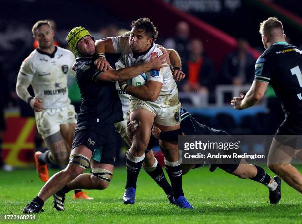 Rohan Janse van Rensburg of Sharks is tackled by Harri Deaves of Ospreys during the Ospreys v Sharks match in the United Rugby Championship at The...