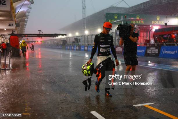 Seventh placed qualifier Lando Norris of Great Britain and McLaren walks in the Pitlane during qualifying ahead of the F1 Grand Prix of Brazil at...