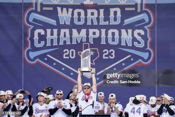 Nathaniel Lowe of the Texas Rangers lifts the Commissioner's Trophy during the World Series Championship celebration at Globe Life Field on November...