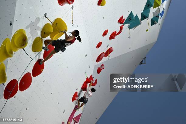 Singapore's Natalie Goh Sihui competes in the women's lead discipline and Indonesia's Tri Ramadani Putra competes in the men's lead discipline during...