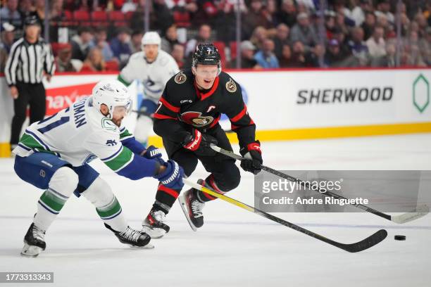 Brady Tkachuk of the Ottawa Senators controls the puck against Mark Friedman of the Vancouver Canucks at Canadian Tire Centre on November 9, 2023 in...