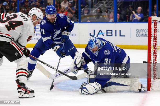 Corey Perry of the Chicago Blackhawks hits the goal post behind Jonas Johansson of the Tampa Bay Lightning as Erik Cernak defends during the first...