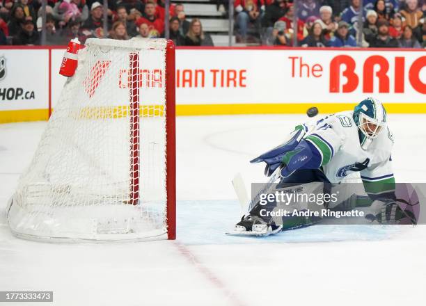 Casey DeSmith of the Vancouver Canucks stretches to make a save on a shot that would hit the post from Drake Batherson of the Ottawa Senators at...