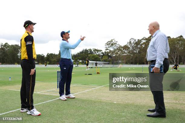 Moises Henriques of New South Wales and Ashton Turner of Western Australia take part in the coin toss alongside Match Referee Stephen James Davis...