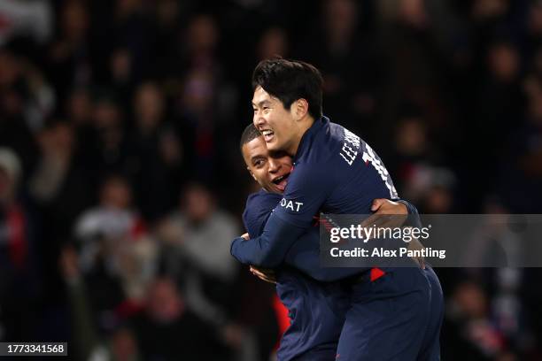 Lee Kang-In of PSG celebrates with team mate Kylian Mbappe after he scores his sides first goal during the Ligue 1 Uber Eats match between Paris...