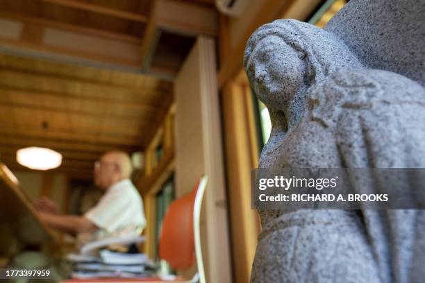 This photo taken on September 5, 2023 shows a religious statue on display as chief Buddhist priest Eiichi Shinohara takes part in an interview with...