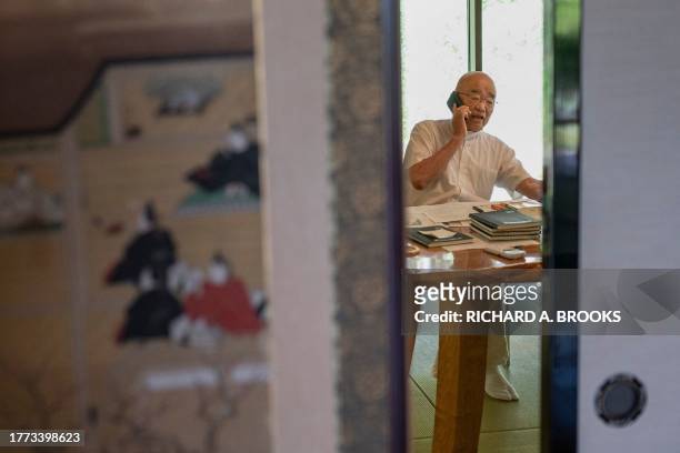 This photo taken on September 5, 2023 shows chief Buddhist priest Eiichi Shinohara speaking on the phone at the end of an interview with AFP at his...